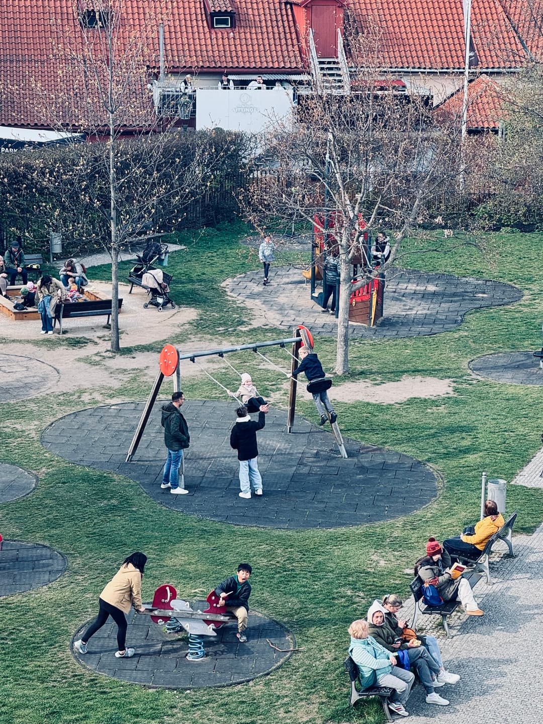 People enjoy an ordinary day at a playground (Prague).